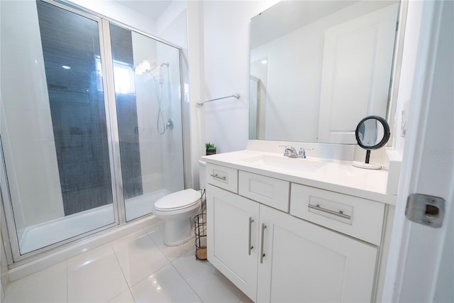 bathroom with tile patterned floors, vanity, toilet, and a shower with door