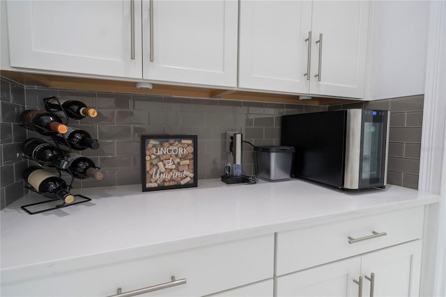 interior details with white cabinetry and backsplash