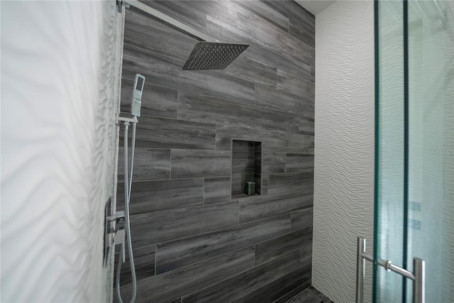 bathroom with tiled shower