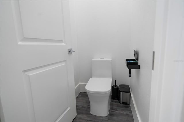 bathroom featuring wood-type flooring and toilet