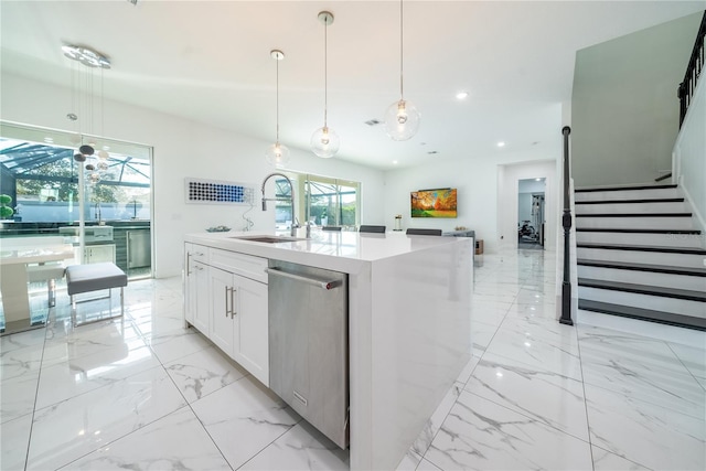 kitchen featuring pendant lighting, sink, dishwasher, a kitchen island with sink, and white cabinets