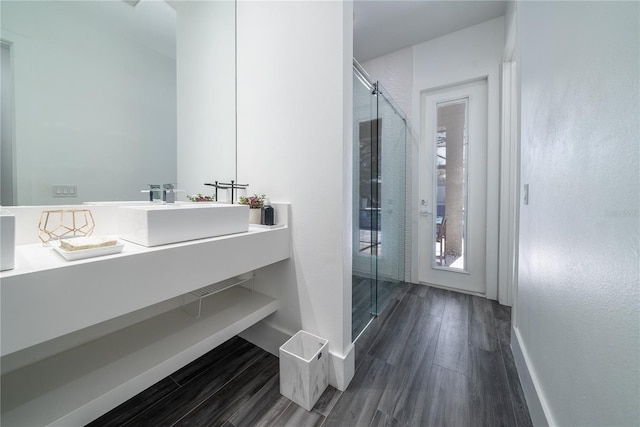 bathroom with vanity, hardwood / wood-style flooring, and a shower with shower door