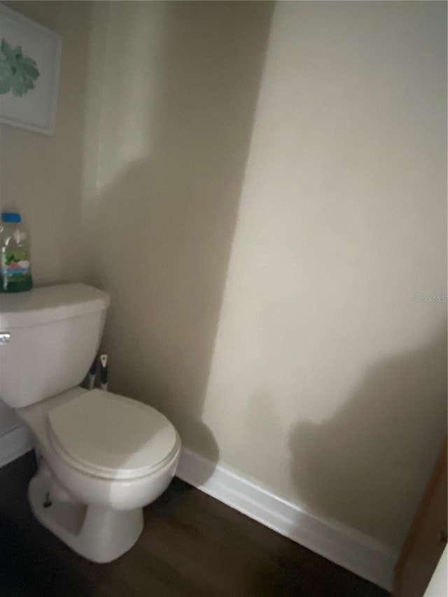 bathroom featuring wood-type flooring and toilet