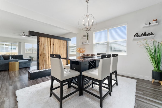 dining space featuring ceiling fan with notable chandelier, hardwood / wood-style floors, and a wealth of natural light