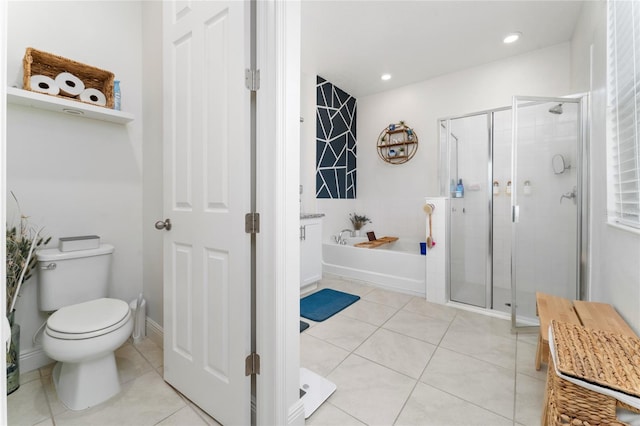 bathroom featuring tile patterned floors, shower with separate bathtub, and toilet