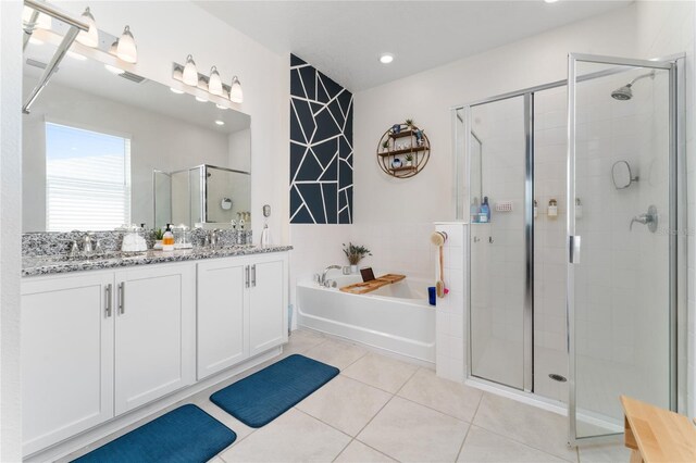 bathroom featuring vanity, tile patterned floors, and shower with separate bathtub