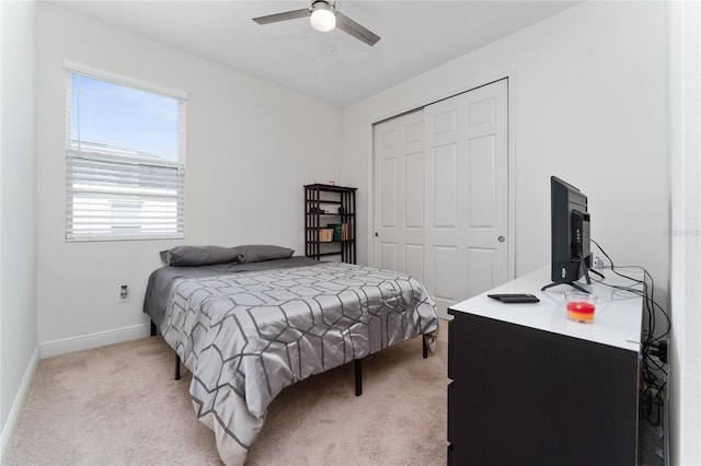 carpeted bedroom featuring a closet and ceiling fan