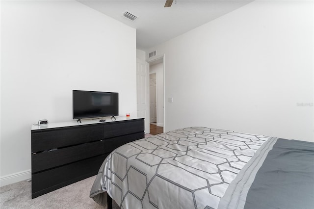 bedroom featuring ceiling fan and light carpet