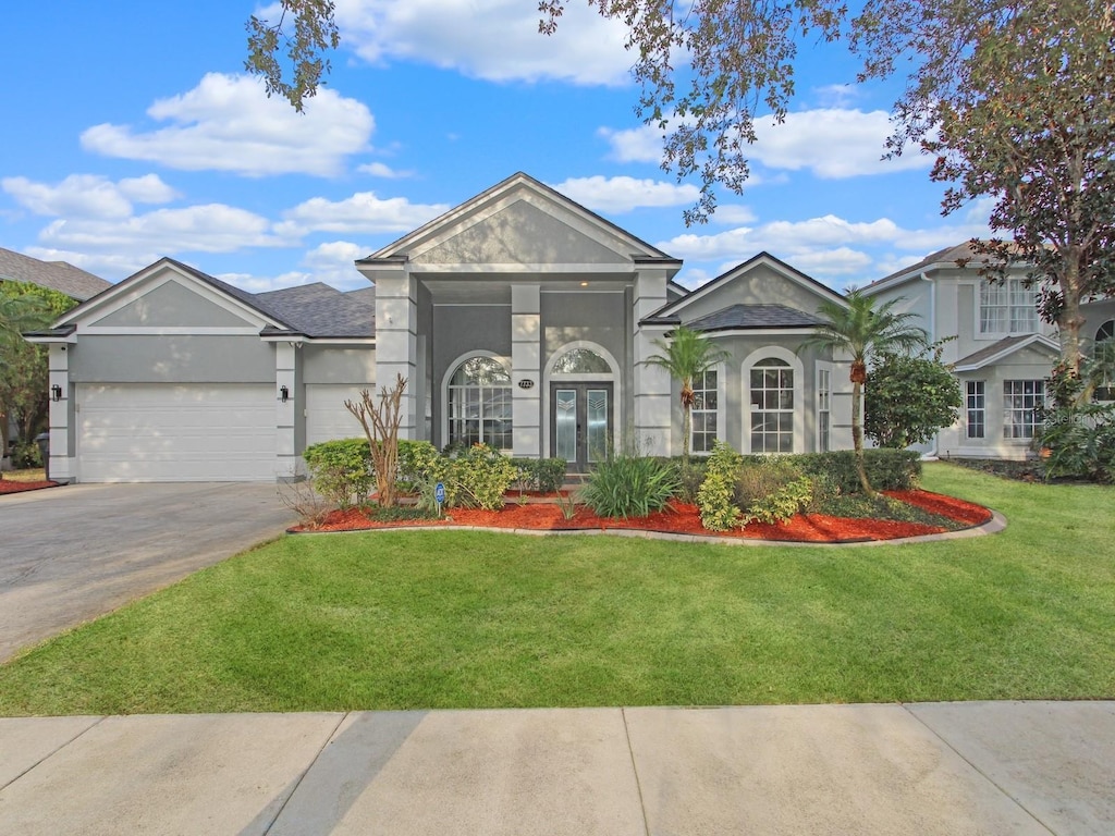 view of front of house featuring a garage and a front yard