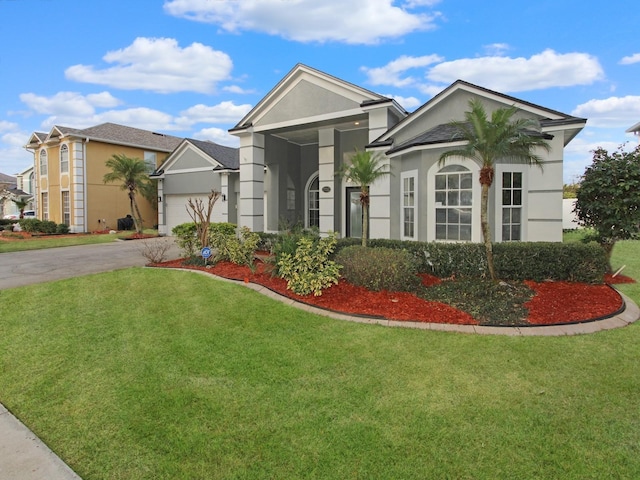 view of front facade with a garage and a front yard