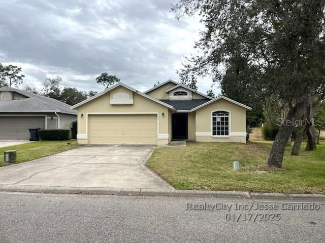 single story home with a garage and a front lawn