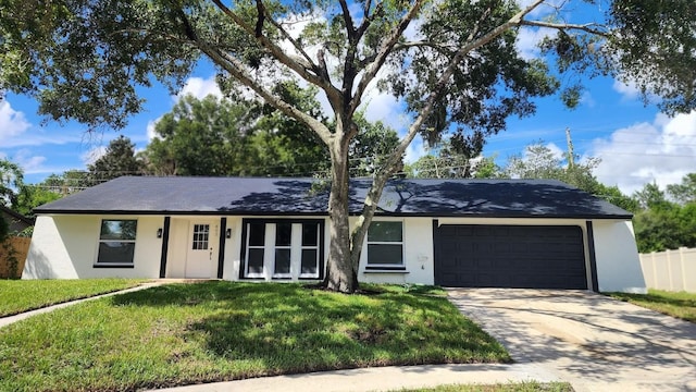 ranch-style house featuring a garage and a front yard