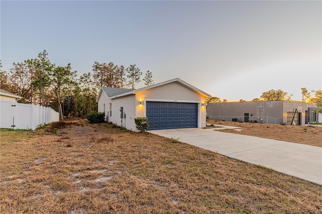 view of front of home with a garage and a yard