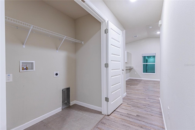 laundry area with hookup for a washing machine, light hardwood / wood-style flooring, and hookup for an electric dryer