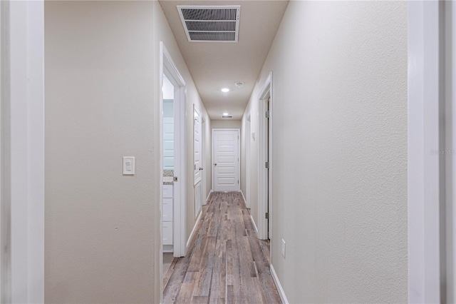 corridor featuring light hardwood / wood-style floors