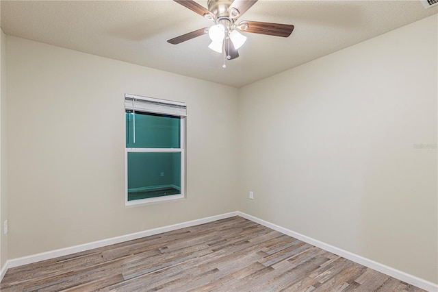 empty room with a textured ceiling, ceiling fan, and light hardwood / wood-style flooring