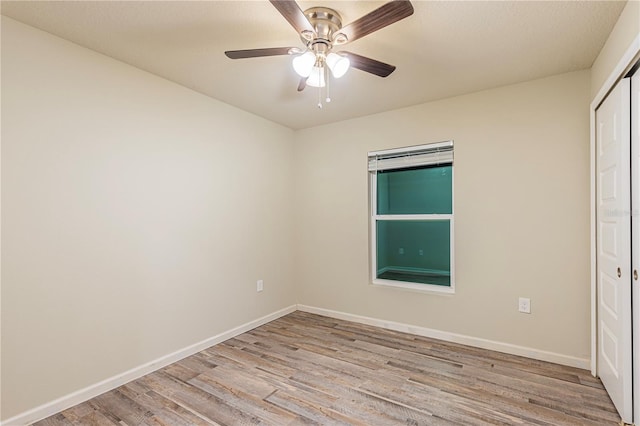 empty room with light hardwood / wood-style floors and ceiling fan