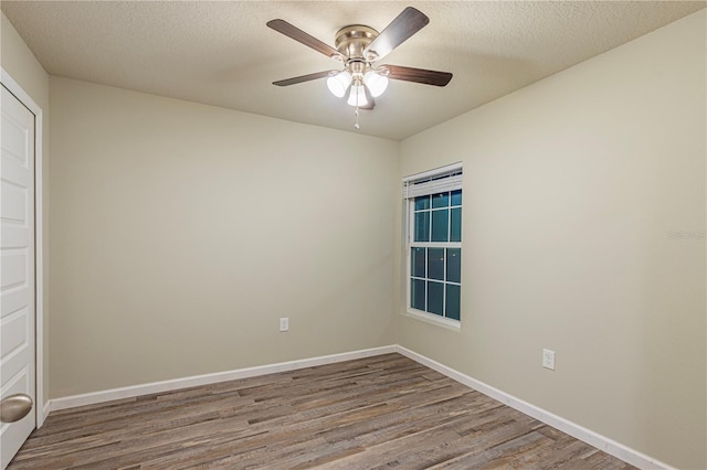 unfurnished room featuring ceiling fan, wood-type flooring, and a textured ceiling