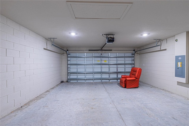 garage with a garage door opener and electric panel