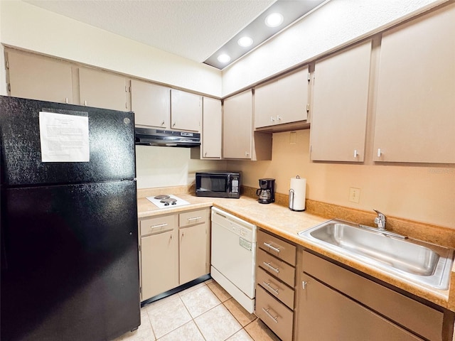 kitchen with light tile patterned flooring, sink, black appliances, cream cabinets, and a textured ceiling