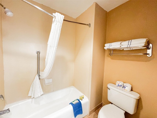 bathroom featuring shower / bath combination with curtain and toilet