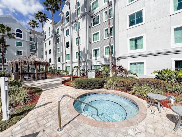 view of pool with a gazebo and a community hot tub