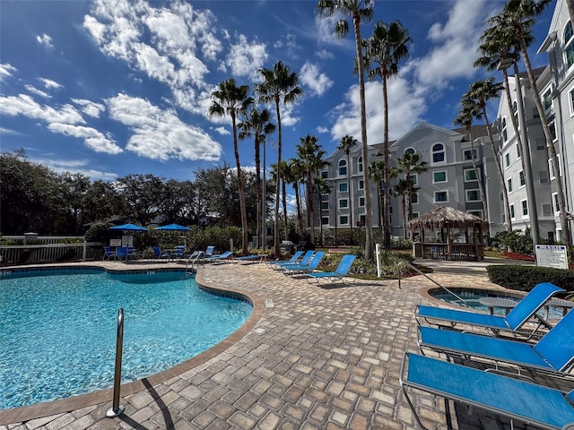 view of pool featuring a community hot tub, a gazebo, and a patio area