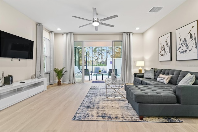 living room with hardwood / wood-style floors and ceiling fan