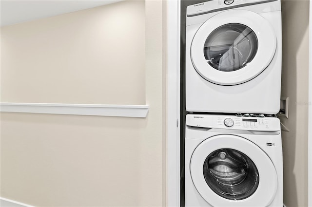 laundry area featuring stacked washing maching and dryer