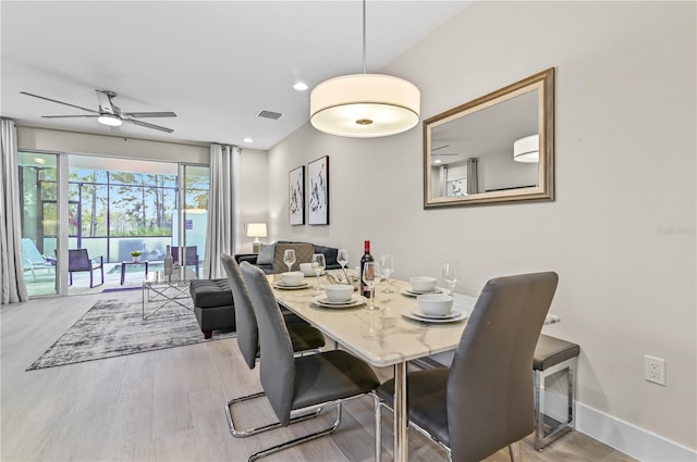 dining room with light hardwood / wood-style flooring and ceiling fan