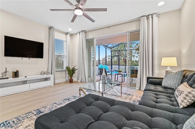 living room featuring hardwood / wood-style floors and ceiling fan