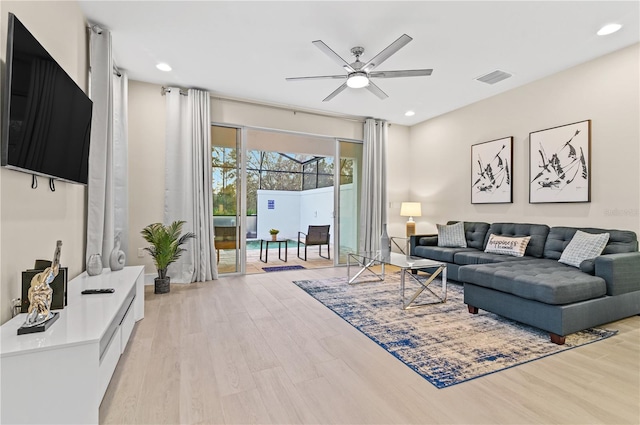 living room with ceiling fan and light hardwood / wood-style floors