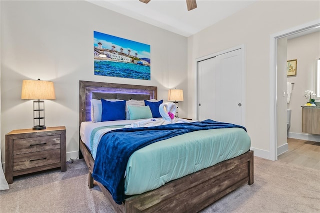 bedroom with ceiling fan, ensuite bath, carpet floors, and a closet