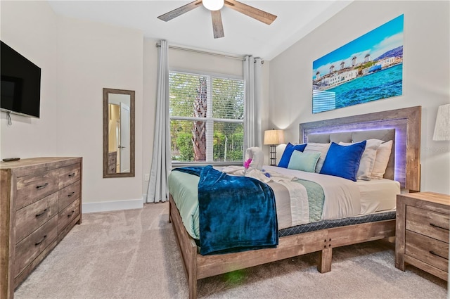 bedroom with ceiling fan and light colored carpet