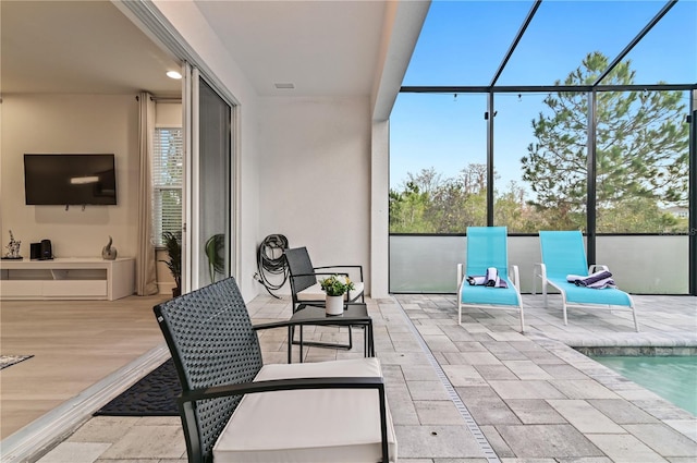 view of patio with glass enclosure