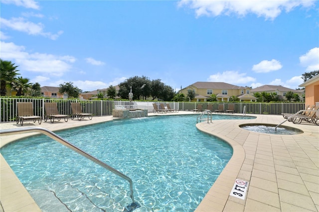 view of pool featuring a community hot tub, a patio, and pool water feature