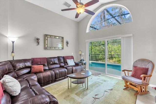 living room with ceiling fan and high vaulted ceiling