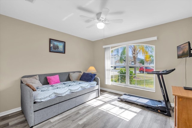 interior space with wood-type flooring and ceiling fan