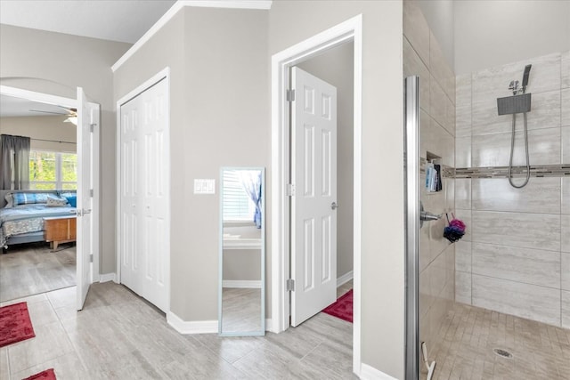 bathroom featuring tiled shower and ceiling fan