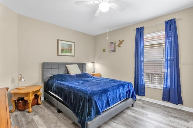 bedroom with wood-type flooring and ceiling fan