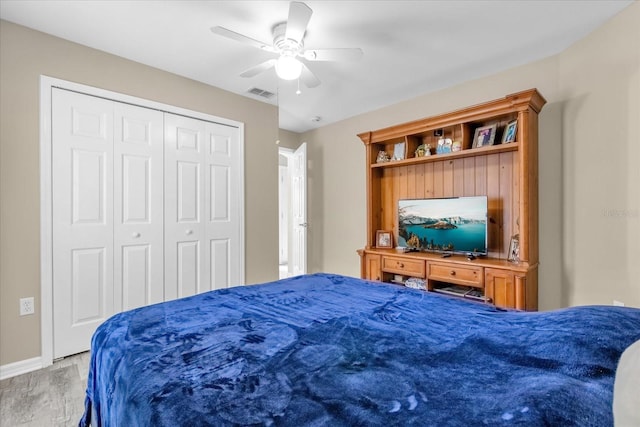 bedroom with wood-type flooring, a closet, and ceiling fan