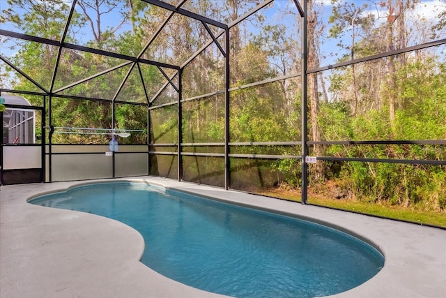 view of pool featuring glass enclosure and a patio area