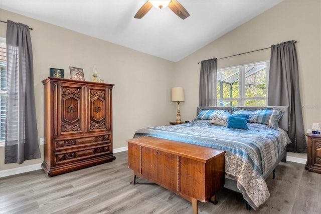 bedroom with vaulted ceiling, light hardwood / wood-style floors, and ceiling fan