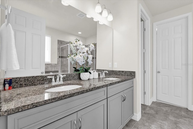 bathroom featuring an enclosed shower and vanity