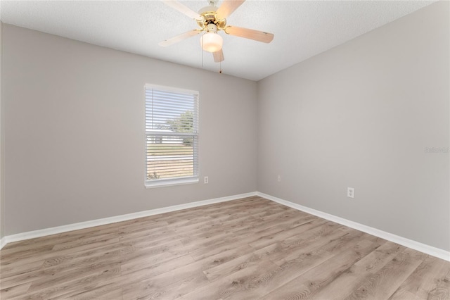 spare room featuring ceiling fan, a textured ceiling, and light hardwood / wood-style floors