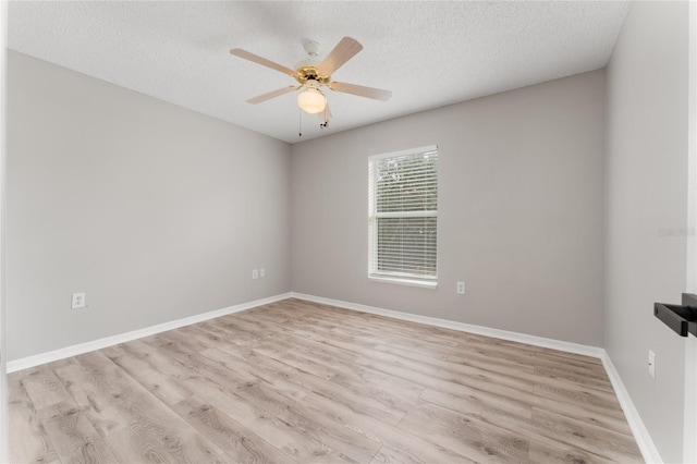 unfurnished room with ceiling fan, light hardwood / wood-style flooring, and a textured ceiling