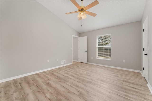 unfurnished room featuring a textured ceiling, light hardwood / wood-style flooring, ceiling fan, and vaulted ceiling