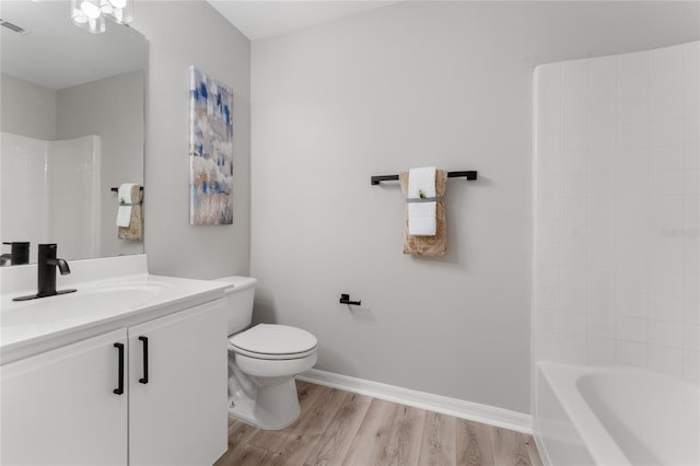 full bathroom featuring vanity, bathtub / shower combination, hardwood / wood-style floors, and toilet