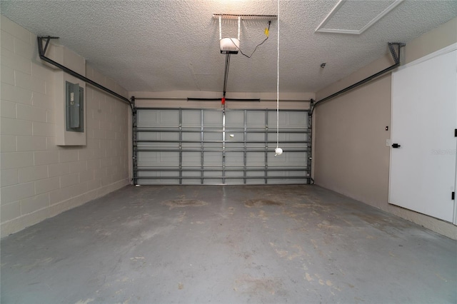 garage with a garage door opener and electric panel