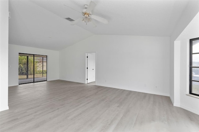 empty room featuring ceiling fan, lofted ceiling, and light hardwood / wood-style floors